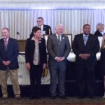 A Picture of a Group of People Standing Before a Podium